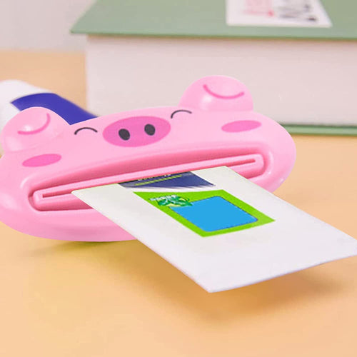 Cute animal-shaped toothpaste tube squeezer on a bathroom counter.
