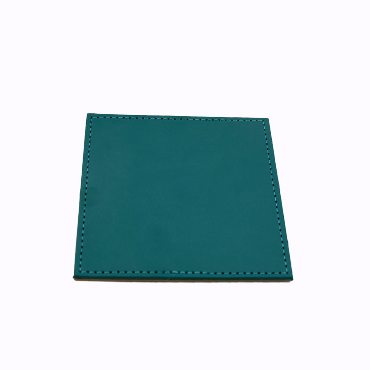 Top-down view of the durable leather coaster providing table protection.